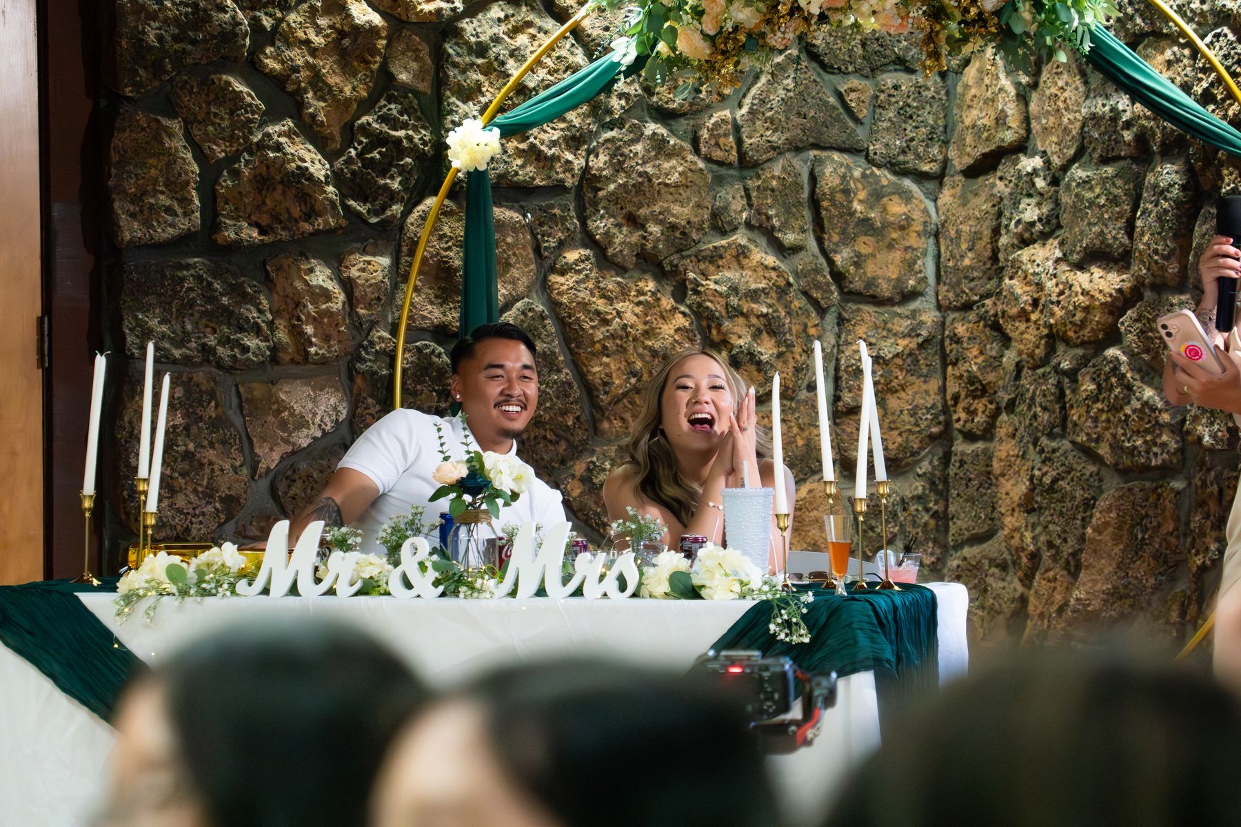 Heaven and Timmy laughing together during a reception toast