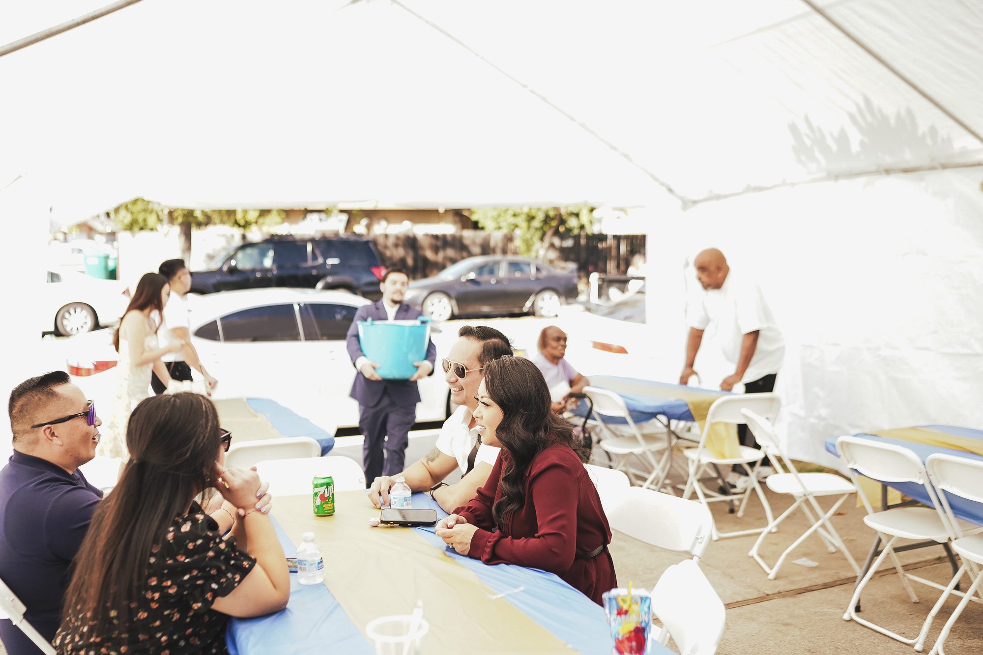 Guests share a meal together beneath the wedding tent