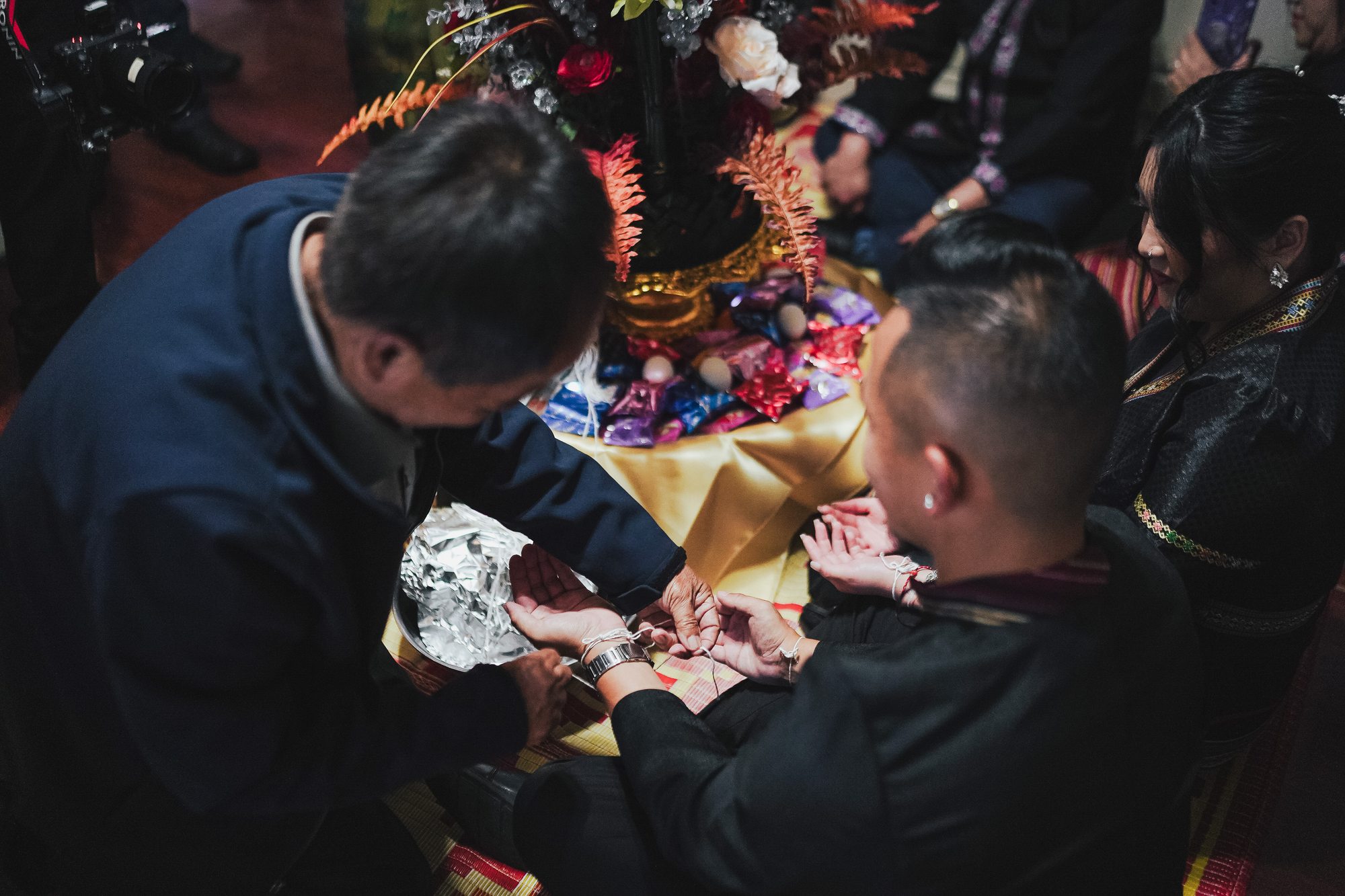 A close view of family hands joining in the ritual