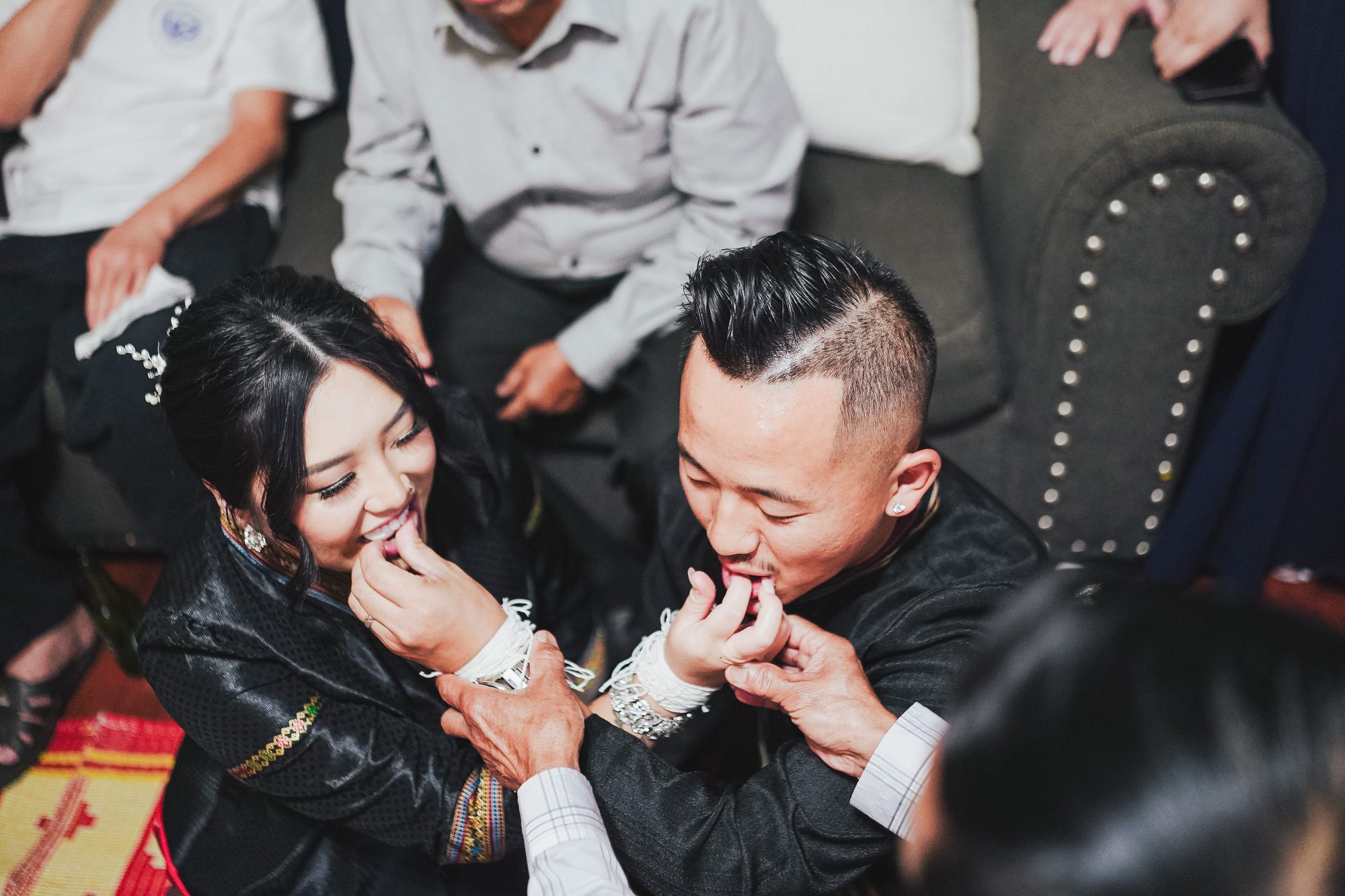 Lisa and Jacob share a playful bite during a family ritual