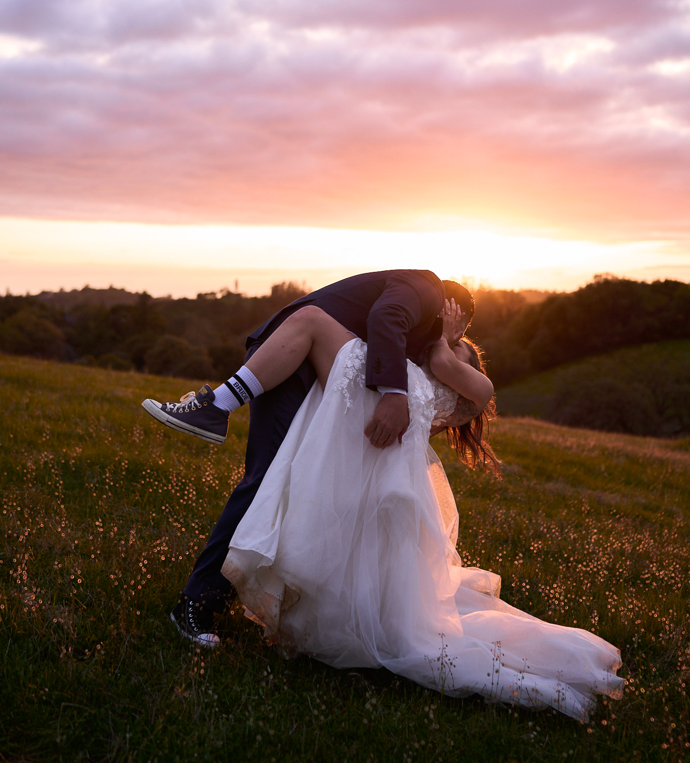 Couple holding lanterns beneath a dramatic sky